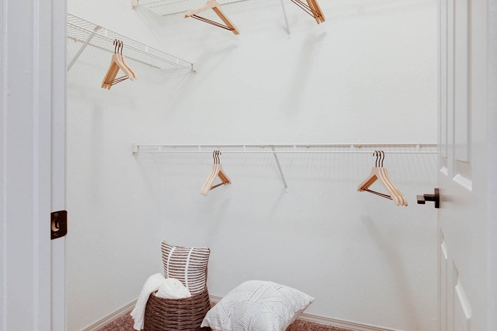 a closet with a chair and a rack with clothes on it at The Olivine, Austin